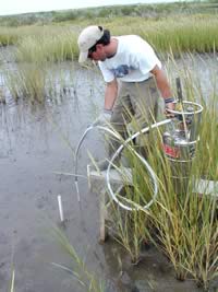 Troy Olney using a tank of liquid nitrogen to freeze a core sample prior to its extraction.